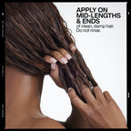 Redken professional hair repair treatment bottle on a clean background