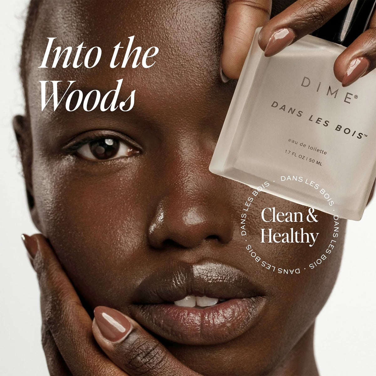 DIME Dans Les Bois 1.7 Ounce bottle on an elegant clean beauty setup.