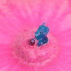Child playing with a revealed mystery unicorn toy inside a colorful bubble bath environment