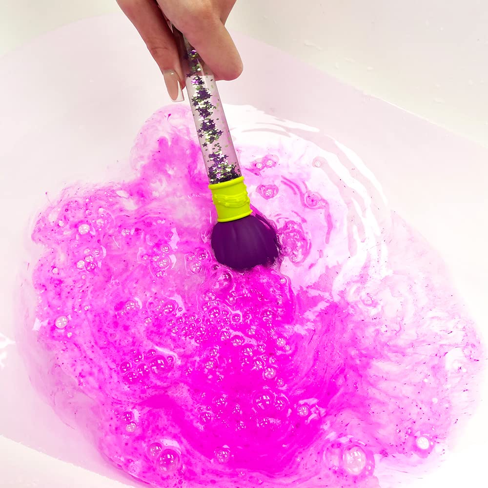A child using the Zimpli bath bomb wand to paint colorful trails in warm bathtub water.