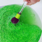 Close up of the four different fruity scented color changing bath balls showing texture and packaging details.