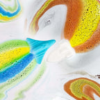 ORIGLAM kids bubble bath fizzers dissolving with rainbow color trails in water