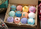 Lifestyle shot of the LifeAround2Angels aromatherapy bath bomb collection next to a relaxing bathtub setup