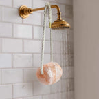 Umaid Himalayan Salt Buddy suspended in a modern shower