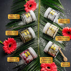 Aromatherapy bath soak jars arranged with the included wooden scoop showing individual labels for lavender and tea tree.