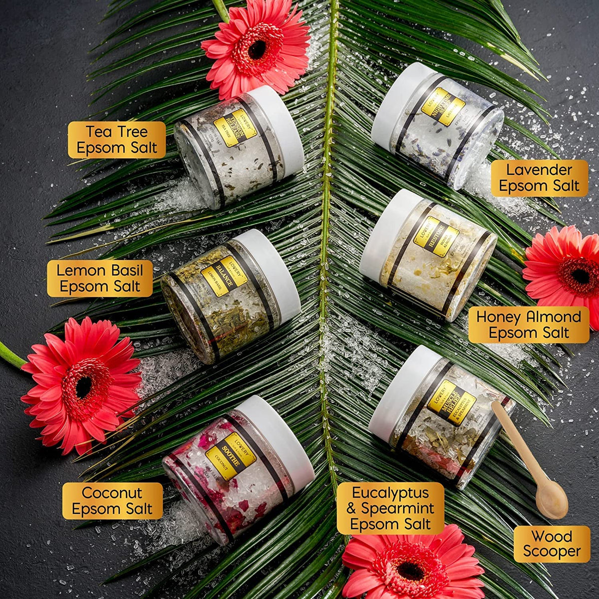 Aromatherapy bath soak jars arranged with the included wooden scoop showing individual labels for lavender and tea tree.
