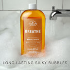 Village Naturals Therapy Breathe bubble bath pour demonstration in tub.
