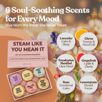 Six colorful aromatherapy shower bombs arranged beautifully next to natural essential oil ingredients.
