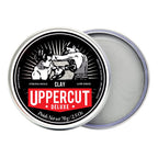 Uppercut Deluxe Clay texturizing hair wax for men showing product texture inside the tin.