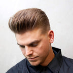 Side angle view of Uppercut Deluxe Clay 70g tin for texturizing modern hairstyles.