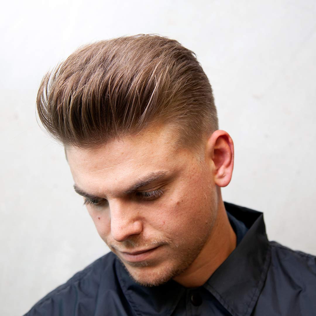 Side angle view of Uppercut Deluxe Clay 70g tin for texturizing modern hairstyles.