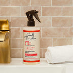 Lightweight anti frizz curl mist bottle on a clean background