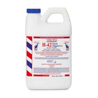 Professional barber tool maintenance with H-42 blade cleaner bottle
