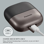 Handheld Panasonic electric shaver in palm for size scale