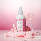 Premium R+Co Candy Stripe Protect And Prep hair mist bottle displaying travel size packaging