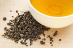 Top view of premium organic green tea leaves in a bowl