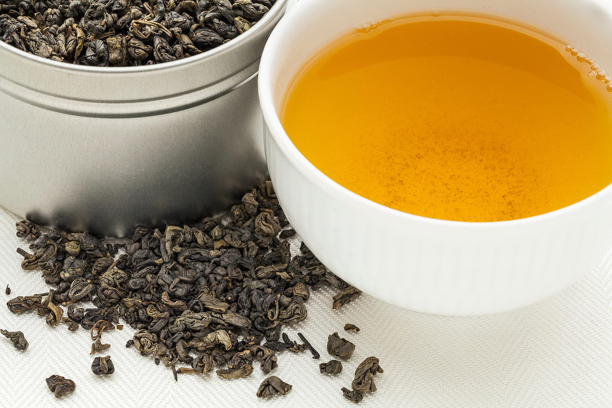 Steeping gunpowder green tea in a traditional glass infuser