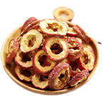 Sun dried seedless hawthorn fruit slices arranged neatly on a wooden surface