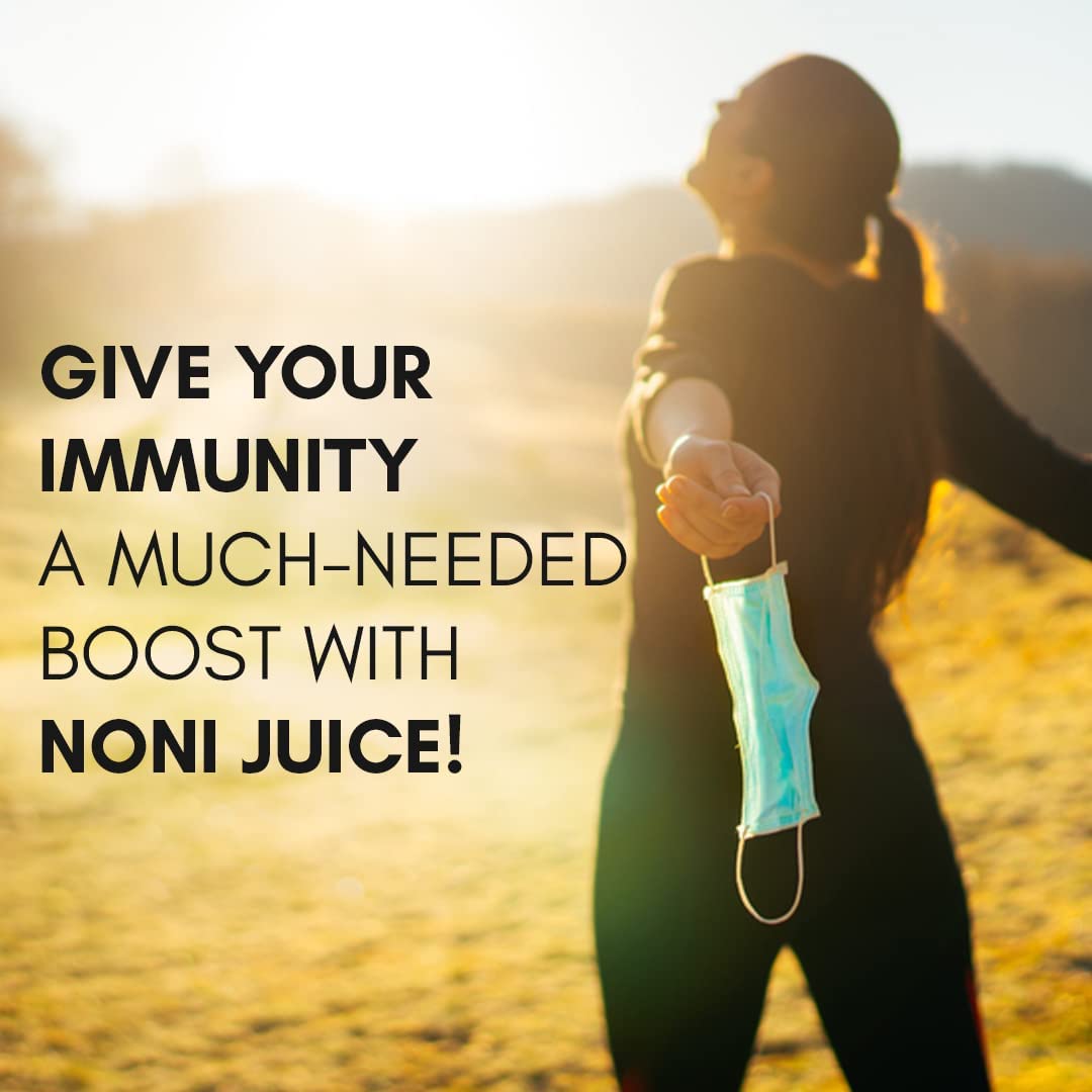 Daily wellness noni fruit juice concentrate poured into a measuring cap for dosage visualization