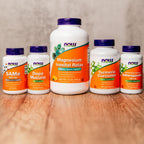Now Foods Turmeric Curcumin bottle held in hand