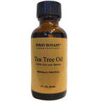 Authentic imported First Botany 1 Fluid Ounce tea tree oil bottle standing upright on a clean backdrop